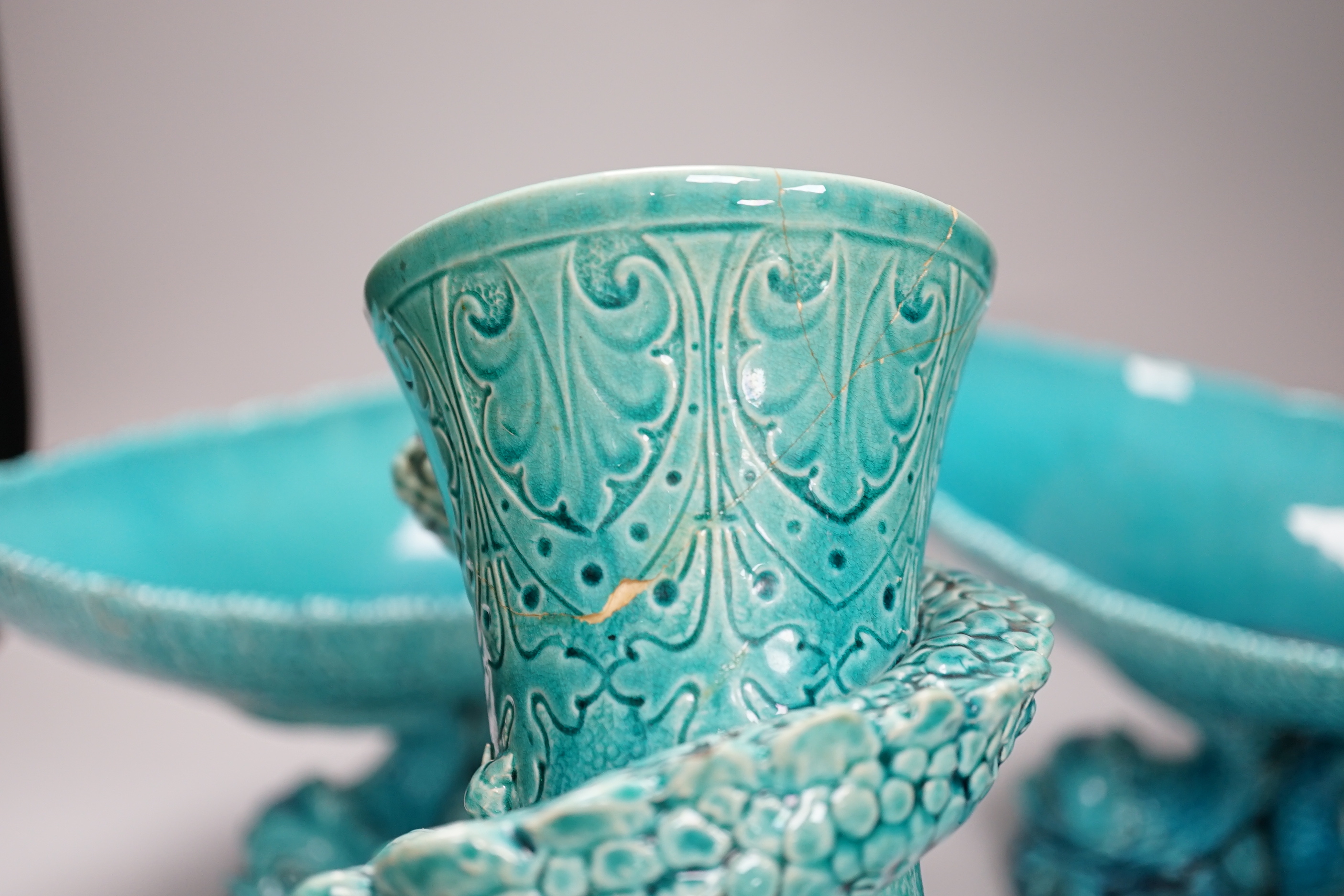 A pair of Burmantofts ‘dolphin’ pedestal bowls and a similar ‘dragon’ vase, 30cm